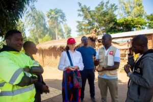 Chilalire and the team checking in with a beneficiary to see how CADECOM's training is being put into practice at home