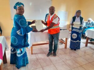 MBS senior quality monitoring officer Donex Msowoya presenting the certificates to the trainers