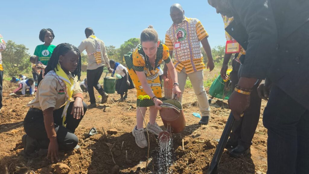 Daria Braithwaite, Holy Childhood Coordinator from the Archdiocese of Boston, USA, plants and waters her tree, symbolizing global solidarity in environmental care at the National Children's Congress.