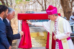 Archbishop Gian Luca Perici unveils the commemorative pillar