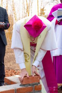 The Apostolic Nuncio, Archbishop Gian Luca Perici, lays a symbolic brick for the new Nunciature