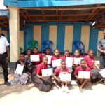 The teachers in all sides posses with the trainees