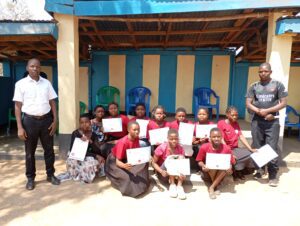 The teachers in all sides posses with the trainees