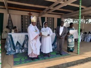 Bishop Mwakhwawa handing over a certificate of recognition to one of the best performing schools during this year's examination (Likuni Girls Catholic Secondary School)
