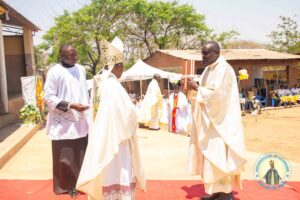 FR-Christian-handing-over-chrstians-register-book-for-the-new-parish-to-the-auxiliary Bishop