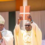 Fr-Philp-showing-the-register-book-to-the-laifaithful
