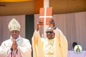 Fr-Philp-showing-the-register-book-to-the-laifaithful