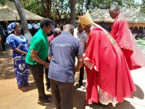 Friends of Likuni Parish presenting tiles to the Auxiliary Bishop