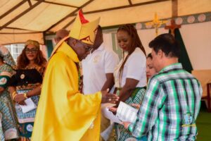 Bishop Mwakhwawa blessing a family from the international community