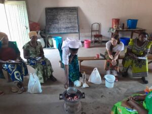 Sister Mulenga training women how to make body lotion