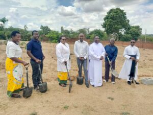 Small Christian Community chairpersons with Father Katundu, demonstrating that they will take a role in building the priest house